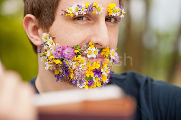 intense look of a flower covered hipster reading Stock photo © Giulio_Fornasar