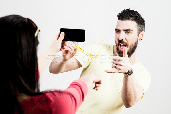 thrilled couple taking mobile photographs and selfies Stock photo © Giulio_Fornasar