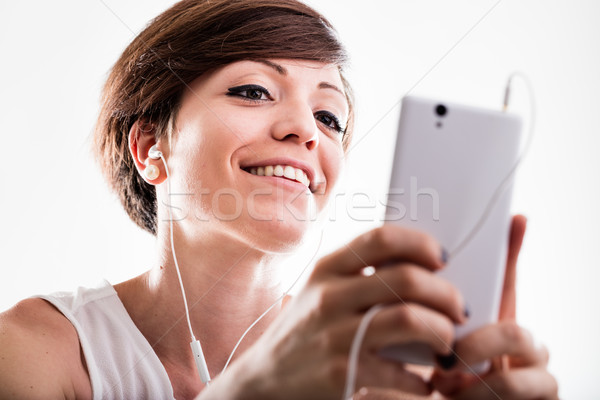 Frau Musik hören Handy Suche Bildschirm Favoriten Stock foto © Giulio_Fornasar