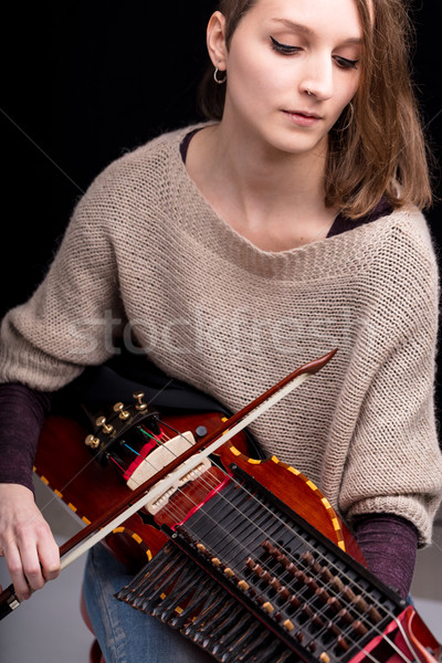woman playing a nyckelharpa musical instrument Stock photo © Giulio_Fornasar