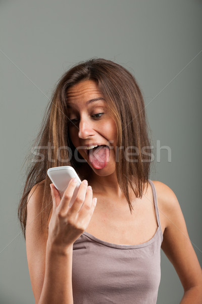 Goofy young woman sticking out her tongue Stock photo © Giulio_Fornasar