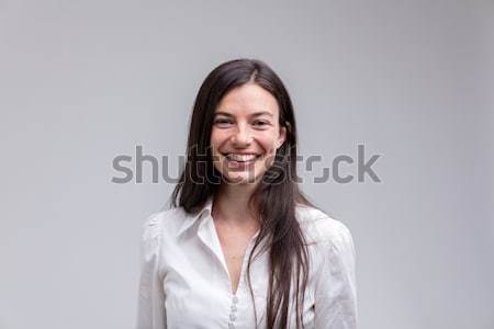 Young long-haired smiling woman in white shirt Stock photo © Giulio_Fornasar