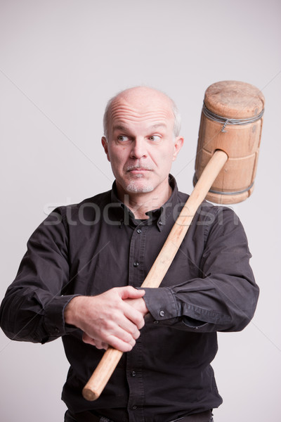 Stock photo: suspect man with a wooden big hammer