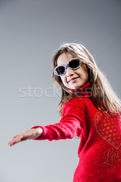 Stock photo: little girl plays as a fashion star or model