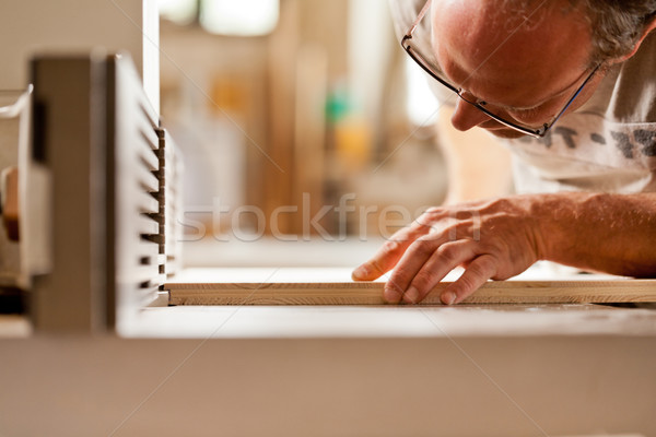 carpenter checking board on a wood shaper Stock photo © Giulio_Fornasar