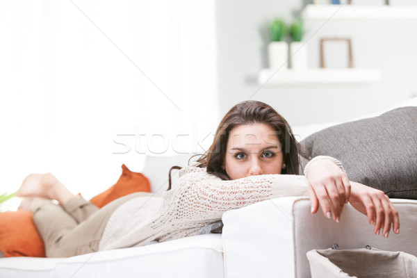 Young woman relaxing lying on a sofa Stock photo © Giulio_Fornasar