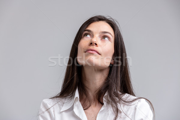 Thoughtful attractive woman looking up Stock photo © Giulio_Fornasar