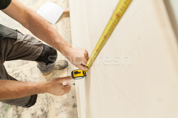 Stock photo: woodworker artisan in his workshop measuring