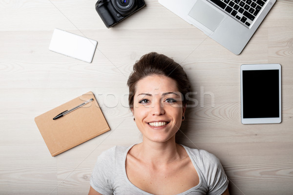 Smiling happy woman surrounded by office supplies Stock photo © Giulio_Fornasar
