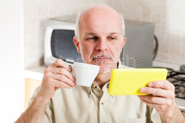 Handsome bearded mature man near microwave oven Stock photo © Giulio_Fornasar