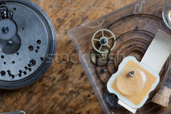 Stock photo: Components of a clock on a watchmakers workbench