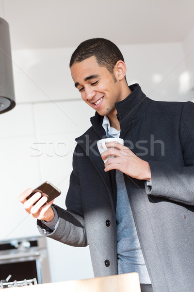 Man taking photo while drinking coffee in kitchen Stock photo © Giulio_Fornasar