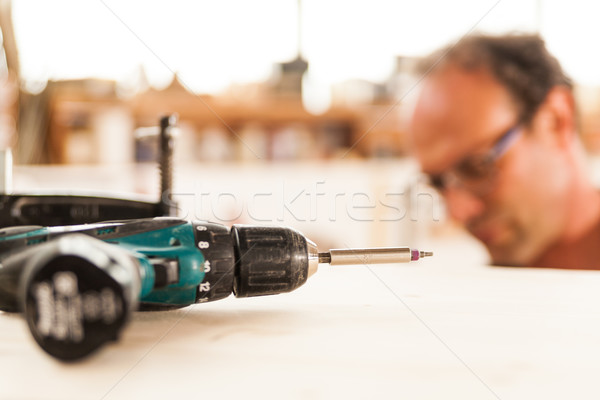 fastener drive in focus and woodworker on background Stock photo © Giulio_Fornasar