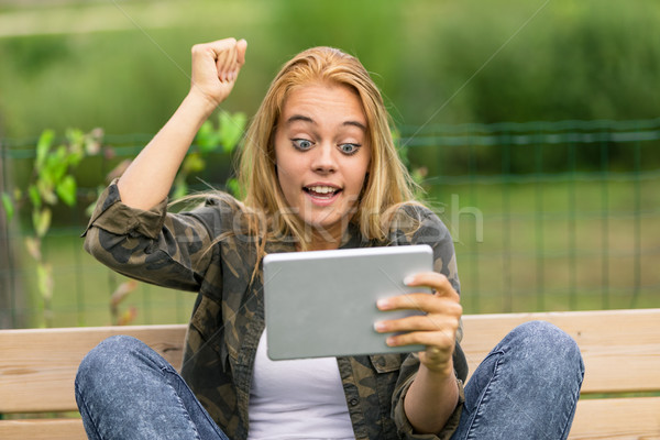 happy surprise for a woman on her social media Stock photo © Giulio_Fornasar