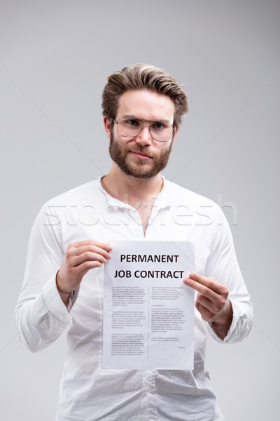 Attractive bearded man holding up a job contract Stock photo © Giulio_Fornasar