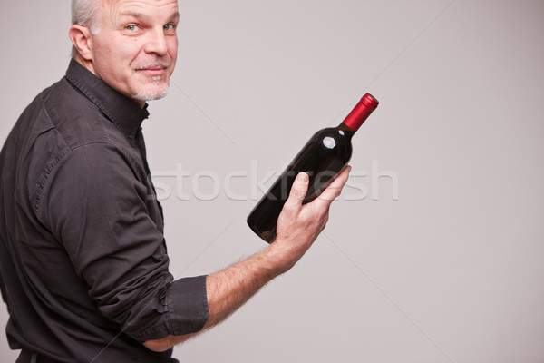 Stock photo: proud wine maker man with a bottle