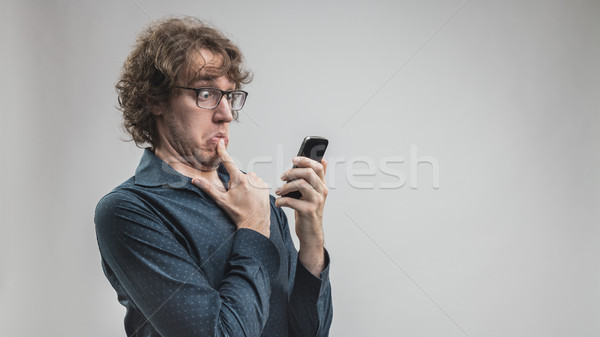 Stock photo: man can't use a mobile phone