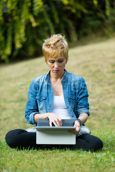 woman on the grass using a tablet sat in lotus position Stock photo © Giulio_Fornasar