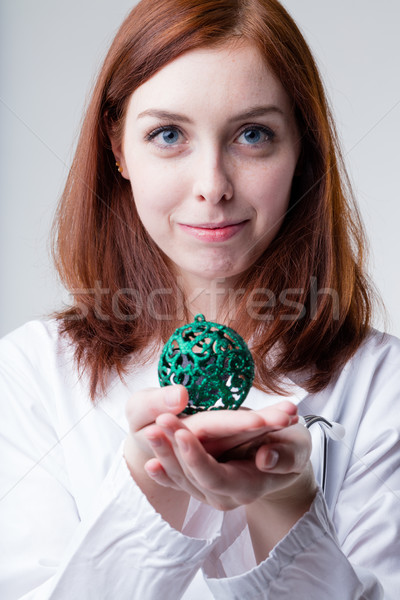 medical doctor holding a christmas ball Stock photo © Giulio_Fornasar