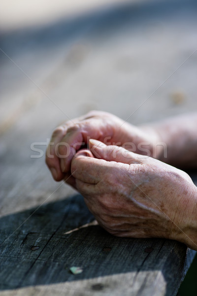 wrinkled hands of an old woman on a table Stock photo © Giulio_Fornasar