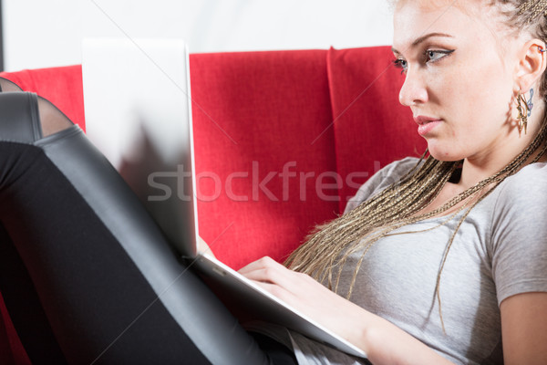 Stock photo: relaxed woman using her laptop on an armchair