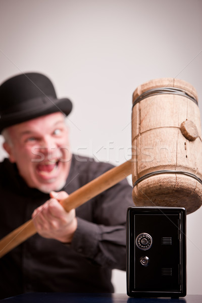 madcap laughs with big hammer on money Stock photo © Giulio_Fornasar