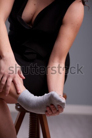 woman holding up her aching foot Stock photo © Giulio_Fornasar