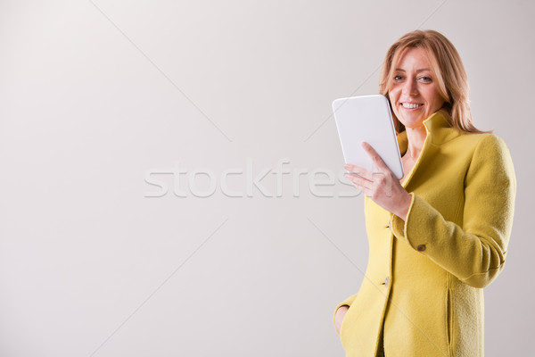 pretty blonde woman using a tablet Stock photo © Giulio_Fornasar