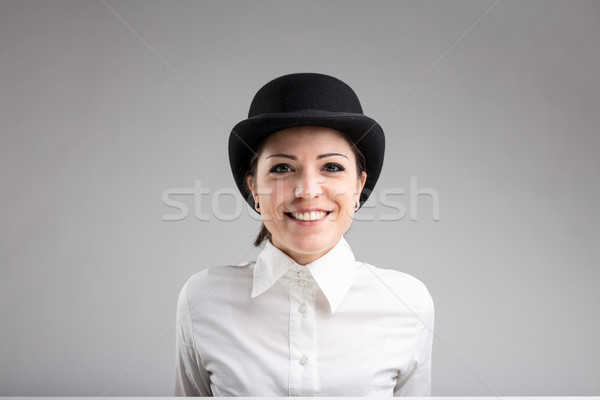 smiling woman in bowler on a gray background Stock photo © Giulio_Fornasar