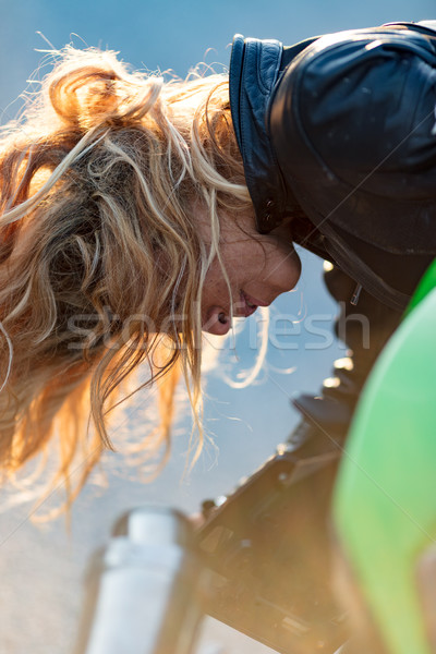 woman setting up her motorcycle to run Stock photo © Giulio_Fornasar