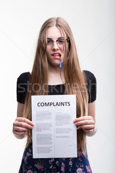Angry young woman holding up a list of complaints Stock photo © Giulio_Fornasar
