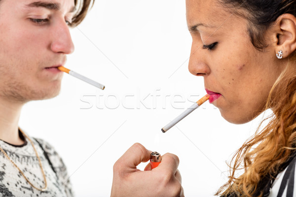 man lighting a cigarette to a woman Stock photo © Giulio_Fornasar