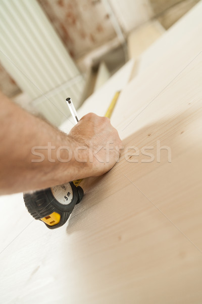 Stock photo: woodworker artisan in his workshop measuring