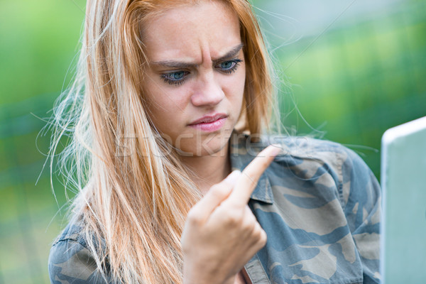 girl disgusted by something on her finger Stock photo © Giulio_Fornasar