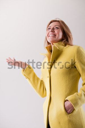 happy mature blonde woman in yellow coat Stock photo © Giulio_Fornasar