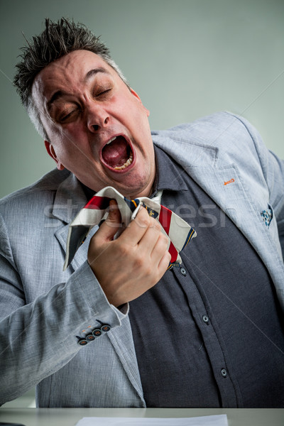 Stock photo: businessman sneezing on his necktie