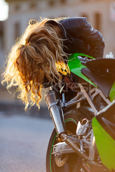 woman setting up her motorcycle to run Stock photo © Giulio_Fornasar