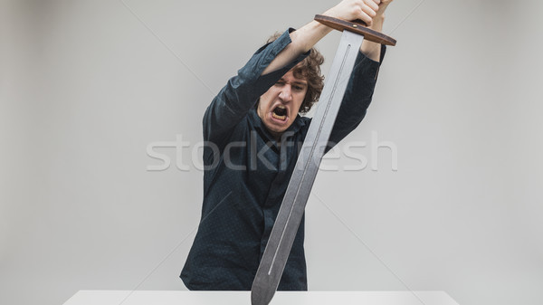 angry man hitting his desk with a sword Stock photo © Giulio_Fornasar