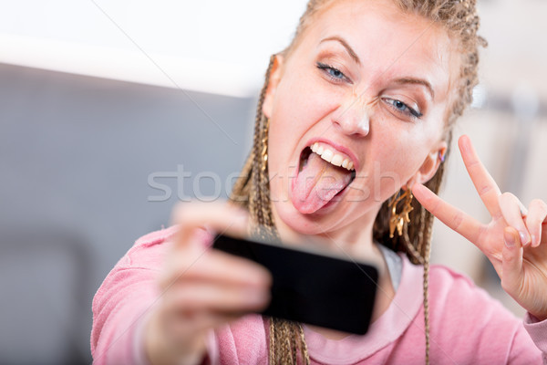 Young woman pulling a goofy face for a selfie Stock photo © Giulio_Fornasar