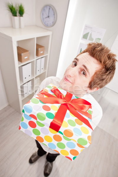 Stock photo: clerk with a big gift in wide-angle