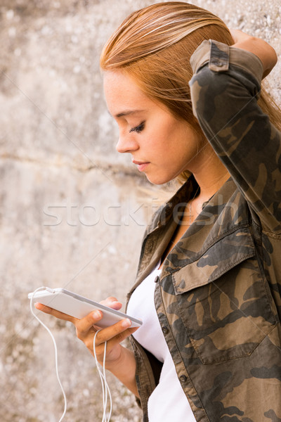 girl plugged into her mobile phone Stock photo © Giulio_Fornasar