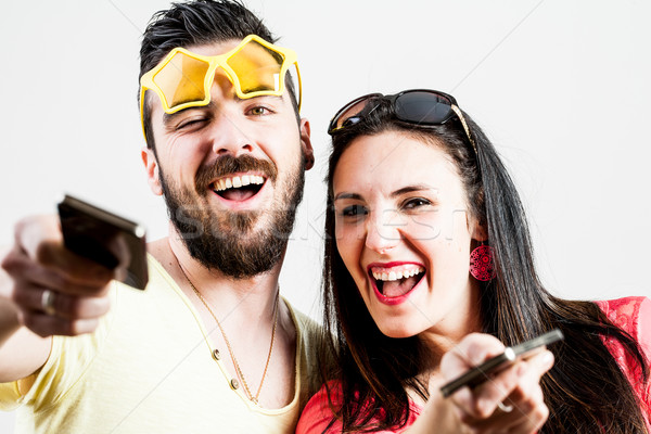 thrilled couple taking mobile photographs and selfies Stock photo © Giulio_Fornasar