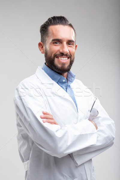 Smiling confident male doctor in a white lab coat Stock photo © Giulio_Fornasar