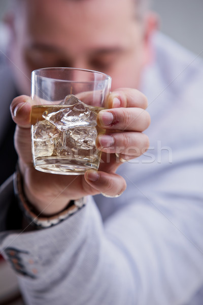 Stock photo: heavy drinker shows a glass of blame