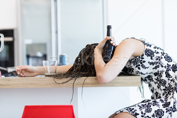Stock photo: Drunk woman with bottle