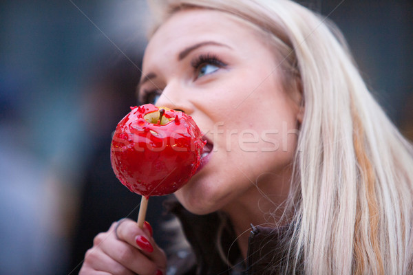blonde woman tasting a red apple candy Stock photo © Giulio_Fornasar