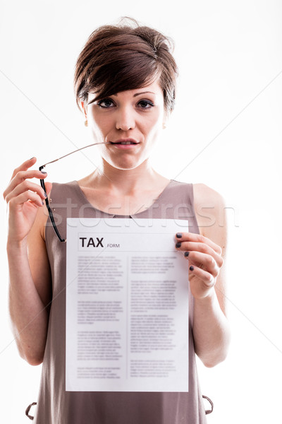 Thoughtful woman holding a tax document Stock photo © Giulio_Fornasar