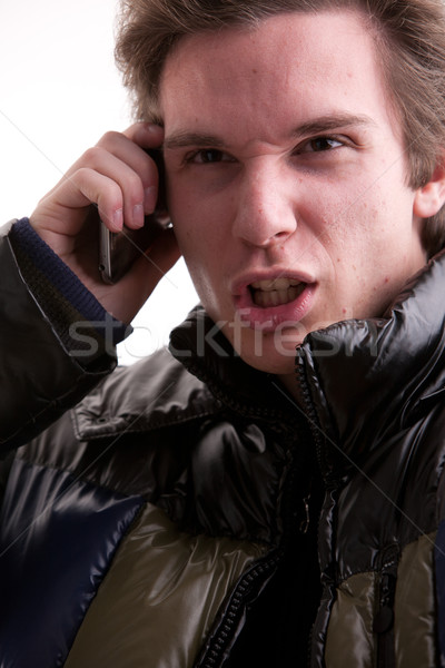 Stock photo: young man upset calling on mobile phone