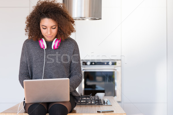 Attractive young woman typing on a laptop Stock photo © Giulio_Fornasar