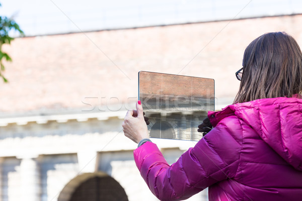 woman in a city taking photographs with transparent tablet Stock photo © Giulio_Fornasar